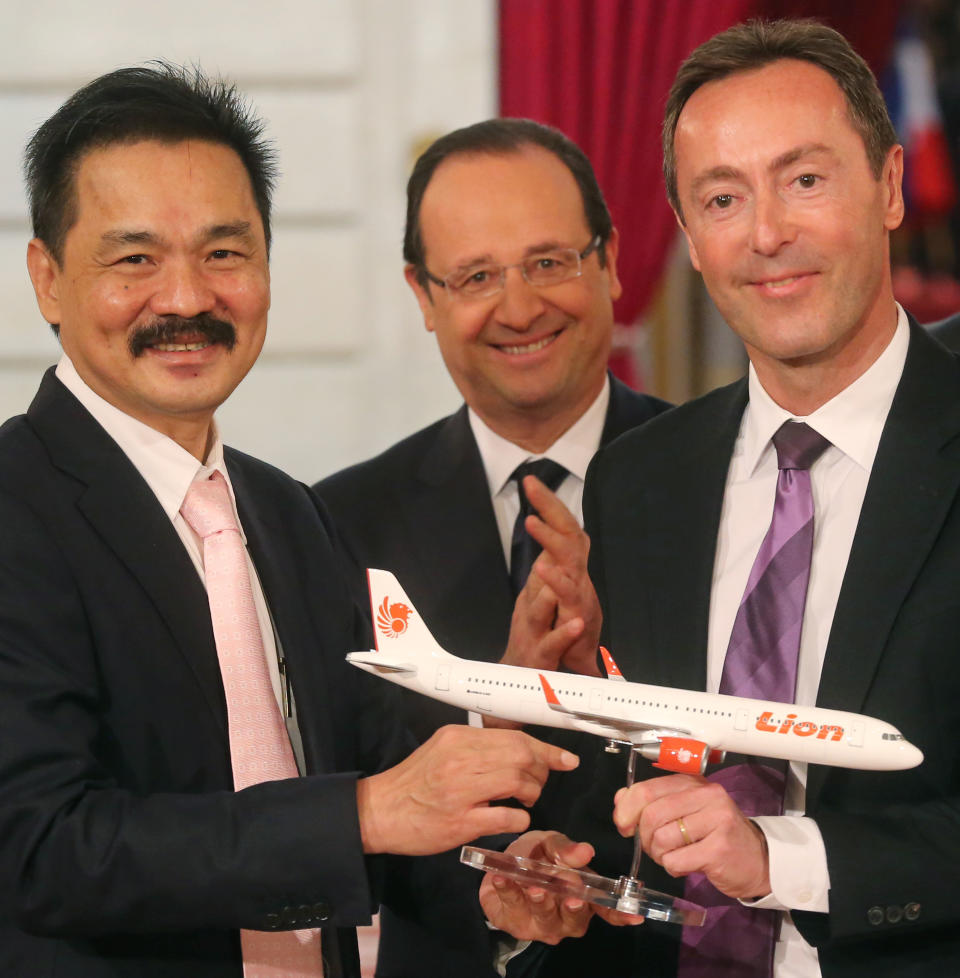 CEO of Lion Air Rusdi Kirana of Indonesia, left, and CEO of Airbus, France's Fabrice Bregier, right, pose with a Airbus 320 model for the media while France's President Francois Hollande stands behind during a signing ceremony at the Elysee Palace in Paris, Monday, March 18, 2013. Indonesian airline Lion Air is to buy 234 short to medium range aircraft from Airbus for 18.4 billion Euro($24 billion), in what is being billed as the biggest civilian deal in the history of the aircraft manufacturer. The contract was announced Monday at the French presidential palace, a sign of the deal's importance to the government. Airbus said it would secure 5,000 jobs at a time when French unemployment hovers around the 10 percent mark. (AP Photo/Michel Euler)