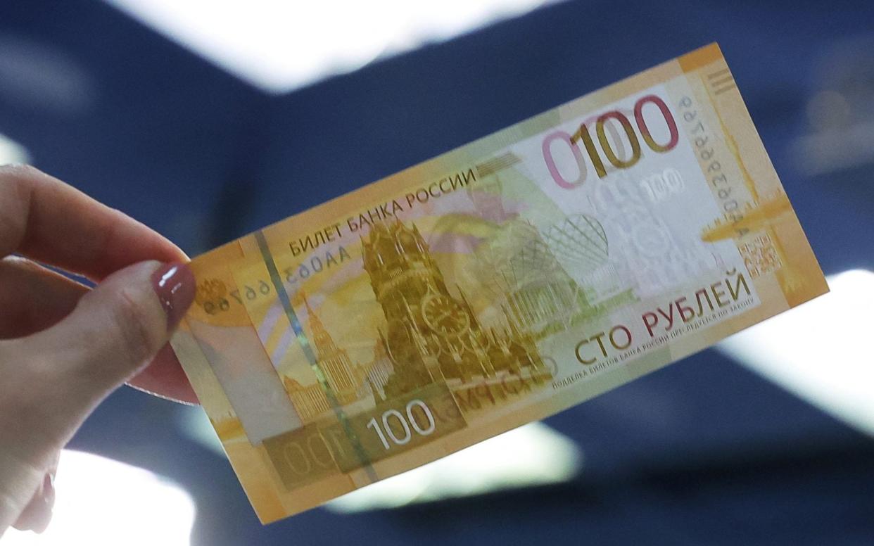 The 100 rouble banknote has been redesigned, but Western sanctions mean it cannot be withdrawn from many cash machines - Evgenia Novozhenina/Reuters