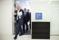 Attorneys representing the Dudek family, Alan Feldman, left, Daniel Mann, and Edward Goldis walk from a news conference, past IKEA's Malm dresser in Philadelphia, Monday, Jan. 6, 2020. IKEA has agreed to pay $46 million to the parents of a 2-year-old boy who died of injuries suffered when a 70-pound recalled dresser tipped over onto him, the family’s lawyers said Monday. (AP Photo/Matt Rourke)