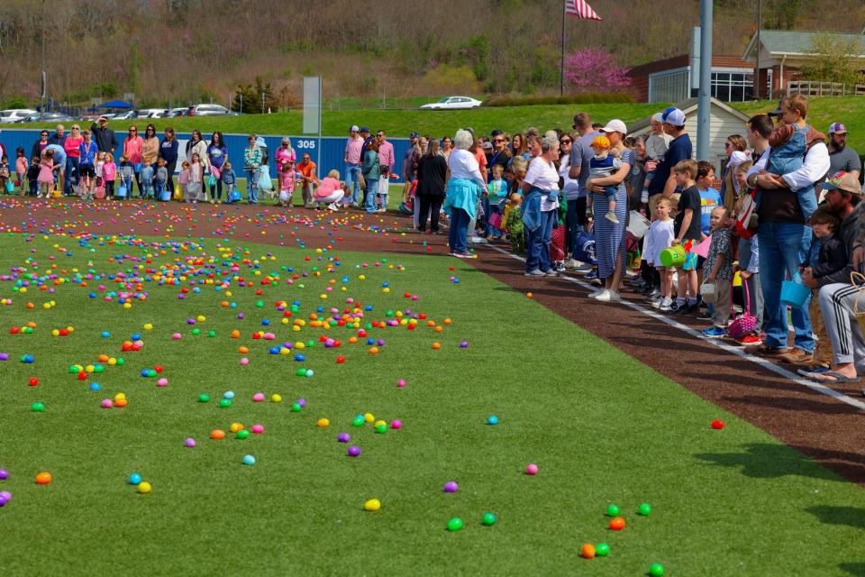 Littles and special friends line waiting for the word to swarm the baseball field at the annual Eggstravaganza.