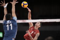 Matthew Anderson, of the United States, spikes a ball against Argentina's Sebastian Sole, during a men's volleyball preliminary round pool B match, at the 2020 Summer Olympics, Monday, Aug. 2, 2021, in Tokyo, Japan. (AP Photo/Manu Fernandez)