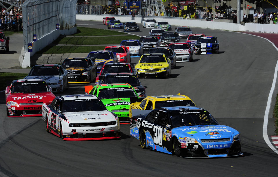 MONTREAL, QC - AUGUST 18: Alex Tagliani of Canada driver of the #30 Oasis/Sennheiser Chevrolet leads the field at the start of the NASCAR Nationwide Series sixth annual NAPA AUTO PARTS 200 presented by Dodge on August 18, 2012 at the Circuit Gilles Villeneuve in Montreal, Quebec, Canada. (Photo by Robert Laberge/Getty Images for NASCAR)