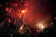 Duesseldorf fans light flares during the German soccer cup match between Bayer 04 Leverkusen and Fortuna Duesseldorf in Leverkusen, Germany, April 3, 2024. (AP Photo/Martin Meissner)