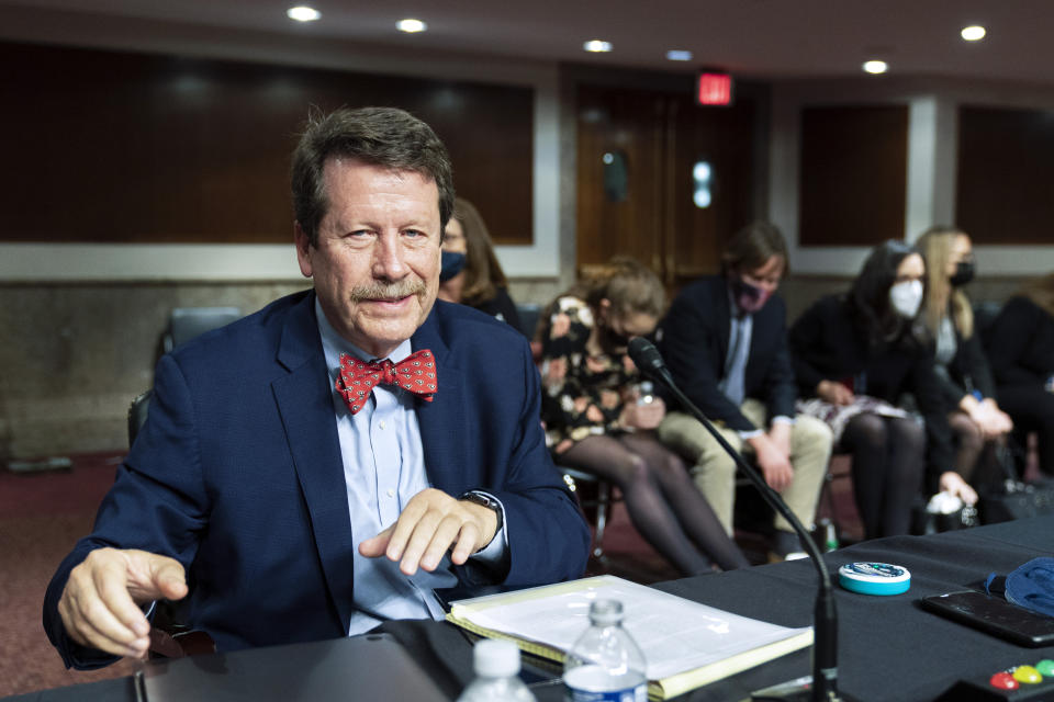 FILE - Dr. Robert Califf gathers his documents as the Senate Committee on Health, Education, Labor and Pension adjourn a hearing on the nomination of Califf to be commissioner of the U.S. Food and Drug Administration on Capitol Hill in Washington, Tuesday, Dec. 14, 2021. Califf, now head of the FDA, says a comprehensive review of the opioid painkillers that triggered the nation's ongoing drug overdose epidemic is in the works. But he faces skepticism about the long-promised review from lawmakers, experts and advocates after years of delay. (AP Photo/Manuel Balce Ceneta, File)