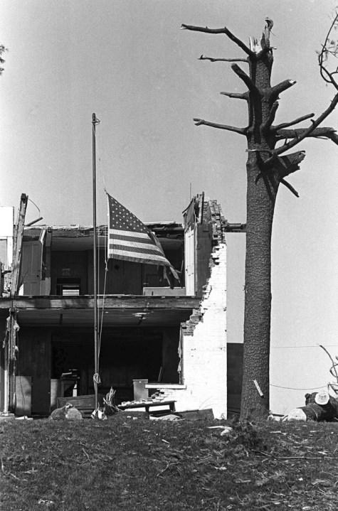 FILE – A flag hangs at half mast between a blasted tree and what is left of a house in Xenia, Ohio, April 3, 1974. The deadly tornado killed 32 people, injured hundreds and leveled half the city of 25,000. Nearby Wilberforce was also hit hard. As the Watergate scandal unfolded in Washington, President Richard Nixon made an unannounced visit to Xenia to tour the damage. Xenia’s was the deadliest and most powerful tornado of the 1974 Super Outbreak. (AP Photo/Steve Pyle, file)