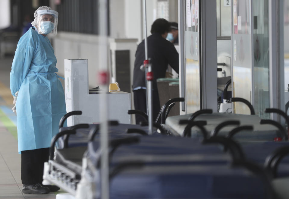 Hospital security wears protective gear at the Princess Margaret Hospital in Hong Kong, Saturday, Feb, 1, 2020. China’s death toll from a new virus continues to rise as a World Health Organization official says other governments need to prepare for“domestic outbreak control” if the disease spreads. (AP Photo/Achmad Ibrahim)