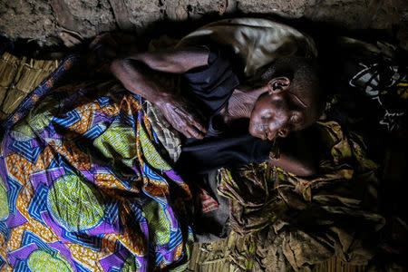 FILE PHOTO: A woman, 60, who is suffering from malaria rests in her house at Kagorwa Pygmy camp on Idjwi island in the Democratic Republic of Congo, November 22, 2016. The woman died from her illness a few days later. REUTERS/Therese Di Campo/File Photo