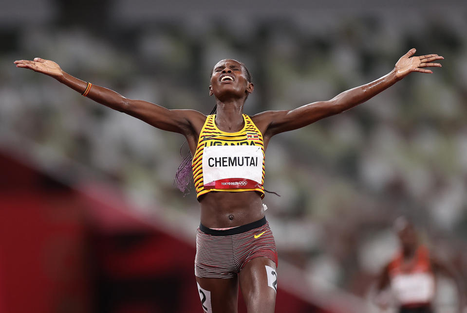 <p>Team Uganda's Peruth Chemutai soaks in her gold medal in the Women's 3000m Steeplechase Final at Olympic Stadium on August 4.</p>