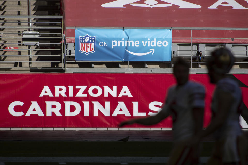 FILE - In this Saturday, Dec. 26, 2020, file photo, An 'NFL on prime video' banner hangs on the field prior to an NFL football game between the San Francisco 49ers and Arizona Cardinals in Glendale, Ariz. The NFL will nearly double its media revenue to more than $10 billion a season with new rights agreements announced Thursday, March 18, 2021 including a deal with Amazon Prime Video that gives the streaming service exclusive rights to “Thursday Night Football” beginning in 2022.(AP Photo/Jennifer Stewart, File)