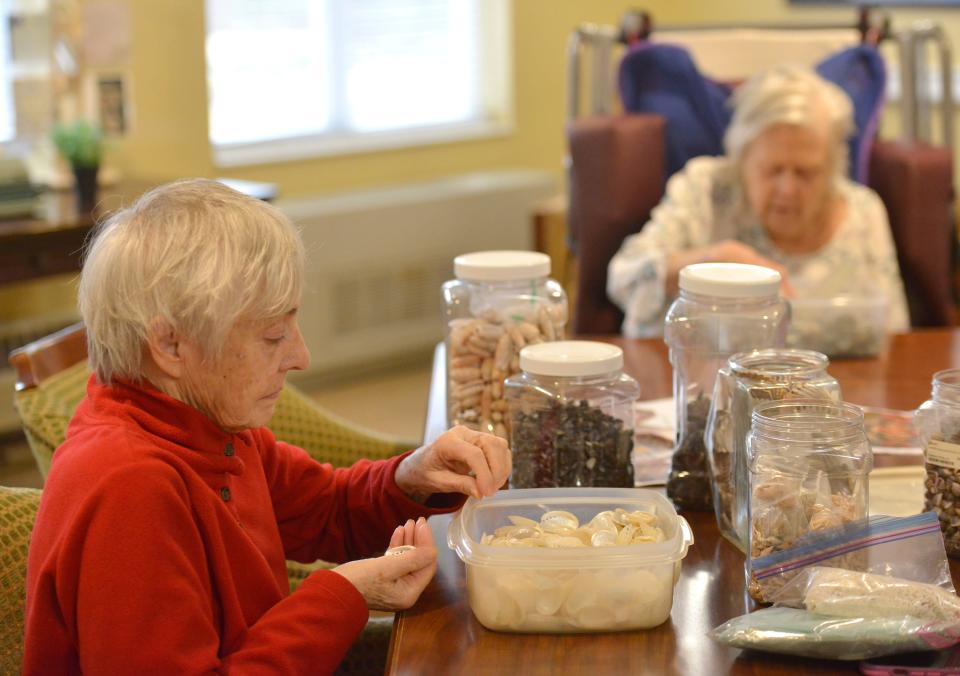 Resident Brenda Treanor helps to select shells for the sailor's valentine in production on Friday by residents and staff at Harbor Point at Centerville. The project was inspired by Harbor Point resident Linda George and her husband Lloyd. To see more photos, go to www.capecodtimes.com.