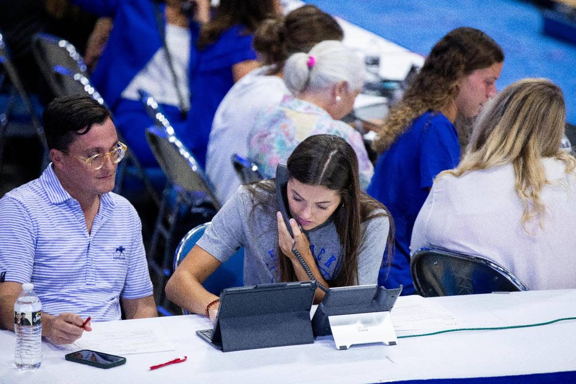Kentucky basketball player Emma King works the phones during Tuesday night’s telethon. King and some of her teammates will also be conducting a camp at North Laurel High School this weekend to benefit flood relief efforts.