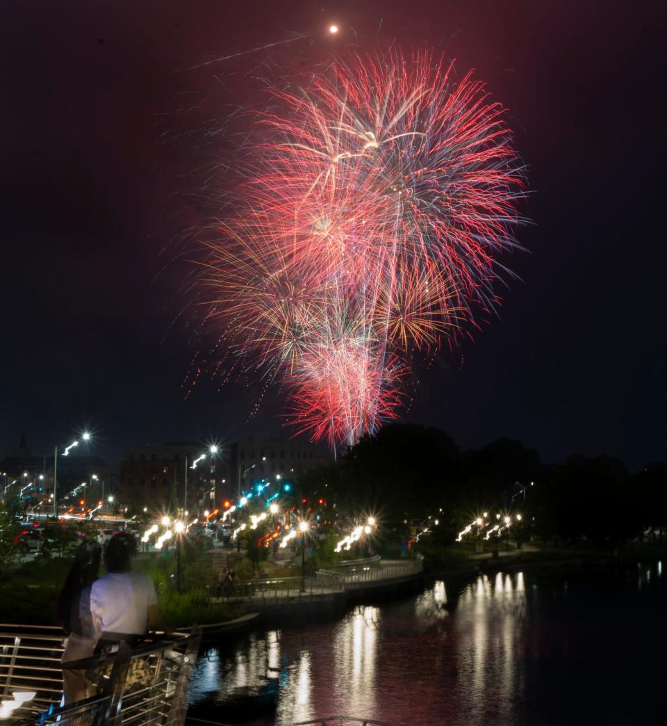 Visitors along the Michael S. Van Leesten Memorial Bridge across the Providence River take in the fireworks display at India Point Park on Sunday evening July 2, 2023, during the city’s annual celebration.