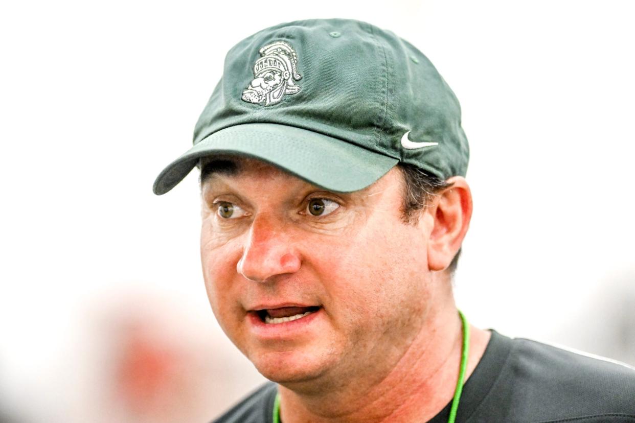 Michigan State's head coach Jonathan Smith talks with the team during camp on Monday, Aug. 5, 2024, at the indoor practice facility in East Lansing.