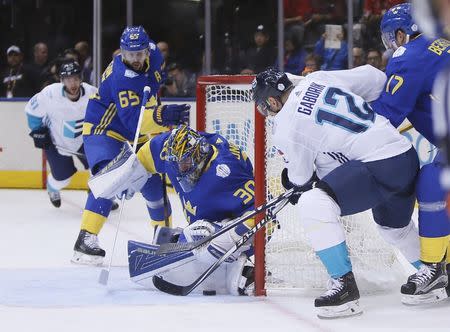 Sep 25, 2016; Toronto, Ontario, Canada; Team Sweden goalie Henrik Lundqvist (30) makes a save on Team Europe forward Marian Gaborik (12) as Team Sweden defenceman Erik Karlsson (65) looks on during the first period of a semifinal game in the 2016 World Cup of Hockey at Air Canada Centre. Mandatory Credit: John E. Sokolowski-USA TODAY Sports