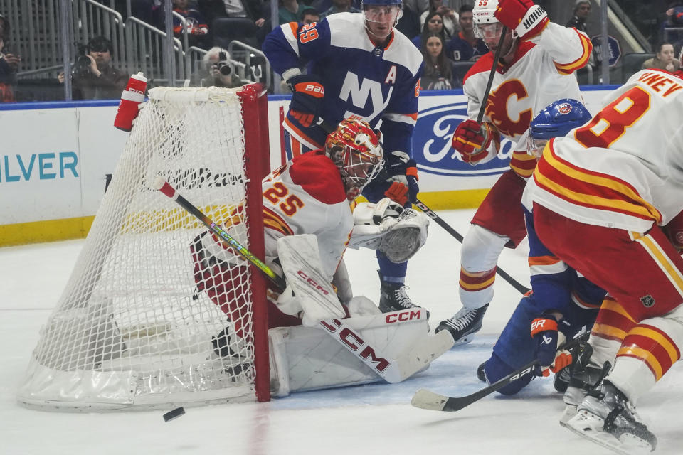 Calgary Flames goaltender Jacob Markstrom deflects a shot during the second period of an NHL hockey game against the New York Islanders, Saturday, Feb. 10, 2024, in New York. (AP Photo/Bebeto Matthews)