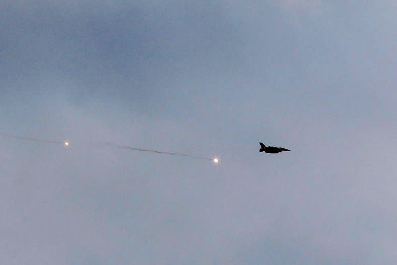 An Israeli fighter jet flies above Rafah in southern Gaza, where airstrikes and ground forces reportedly inflicted "mass casualties" while targeting "terrorists" on Wednesday. Photo by Ismael Mohamad/UPI