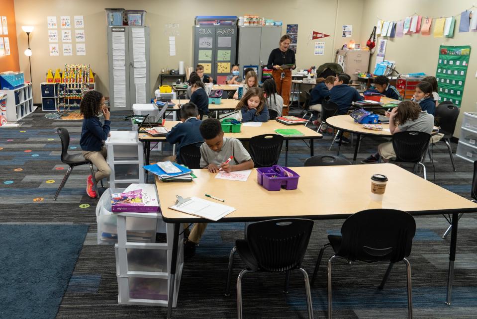 Jhace Moore, 8, spends his morning learning homophones and homonyms Monday, March 13, 2023, in his second grade class at Paramount Brookside Charter School in Indianapolis. Moore and his family were left scrambling looking for a school after his old one, Him by Her Charter School, shut down suddenly in January. 