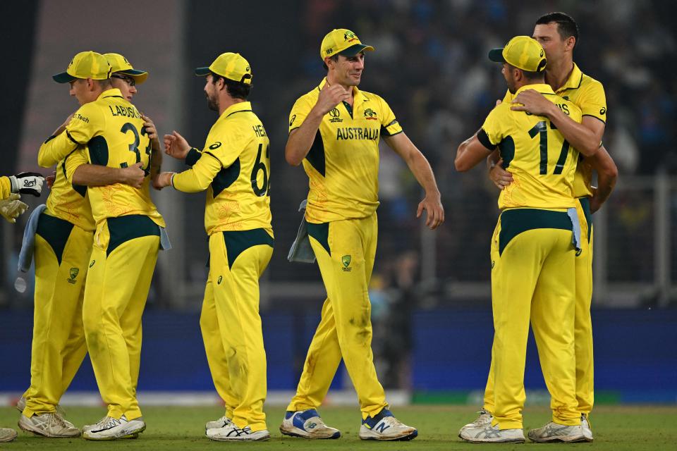 Australia's captain Pat Cummins (C) celebrates with teammates after their win at the end of the 2023 ICC Men's Cricket World Cup one-day international (ODI) match against England at the Narendra Modi Stadium in Ahmedabad on November 4, 2023. (Photo by Money SHARMA / AFP) / -- IMAGE RESTRICTED TO EDITORIAL USE - STRICTLY NO COMMERCIAL USE -- (Photo by MONEY SHARMA/AFP via Getty Images)