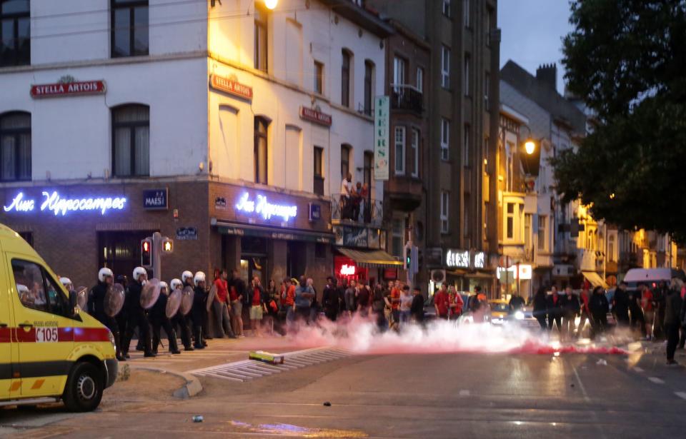 <p>Belgian riot police line up as a flare smokes on a street in Brussels on July 10, 2018, after France defeated Belgium in the first semi-final of the 2018 Russia World Cup football match in Saint Petersburg (Photo by Aris Oikonomou / AFP) </p>