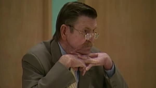 closeup of a man in a suit and tie in court