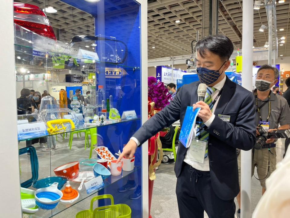 富強鑫總經理王俊賢展示射塑機所製作的成品。劉家瑜攝