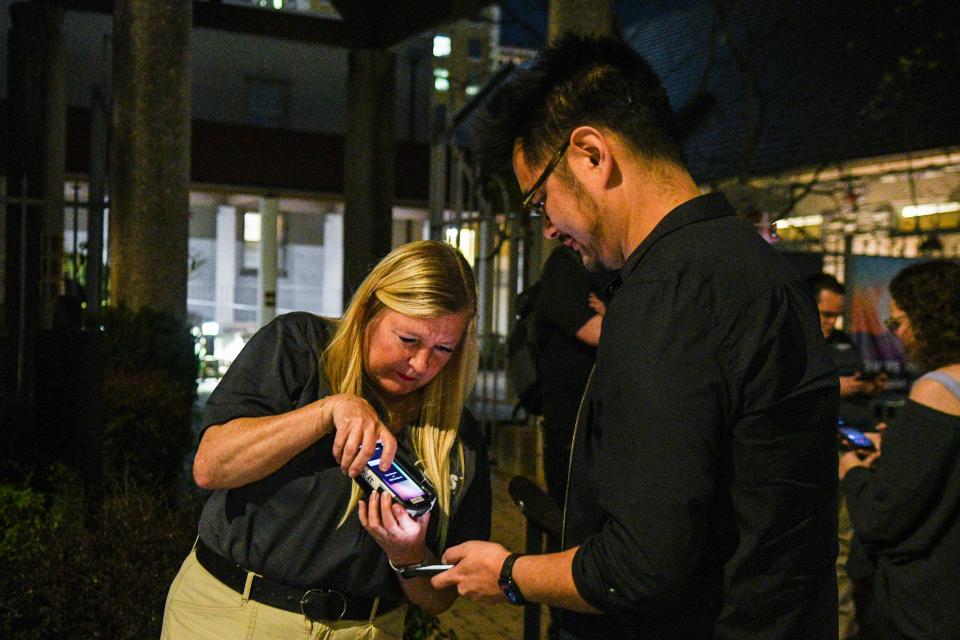 Amanda Kirby scans a ticket from a Big Ears attendee to see Andre 3000 at the St. John's Cathedral on March 21.