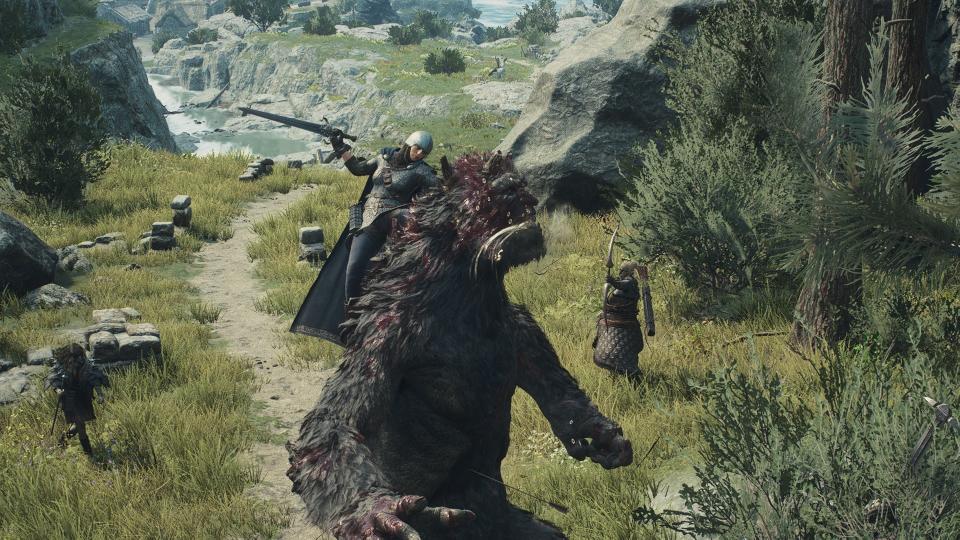 A warrior holding on to the back of an ogre in Dragon's Dogma 2.