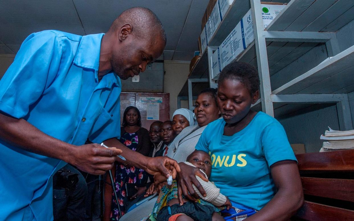 A health worker prepares to give a dose of the Malaria Vaccine to the first recipient in Malawi in April - AFP