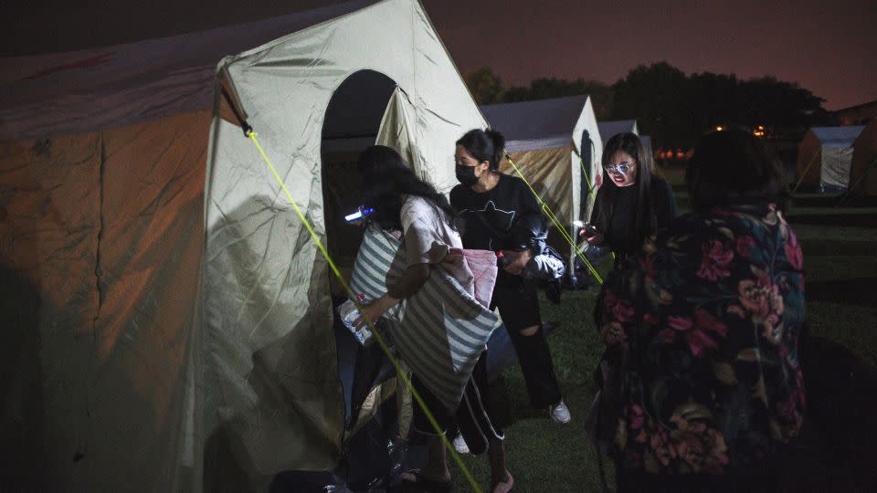 Earthquake affected people enter a tent at a temporary reception center at a local school in Hualien on April 3, 2024. - Sam Yeh/AFP/Getty Images