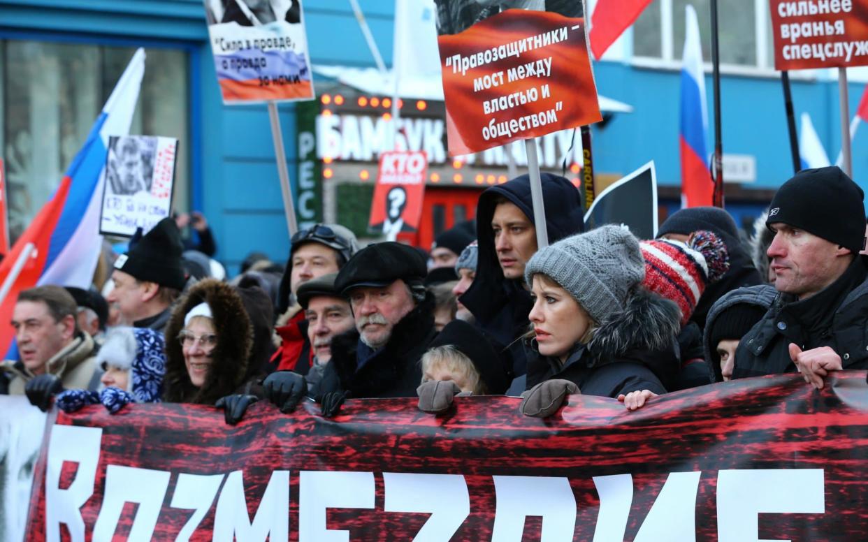 Marchers in Moscow carry a sign with Boris Nemtsov's face and the words
