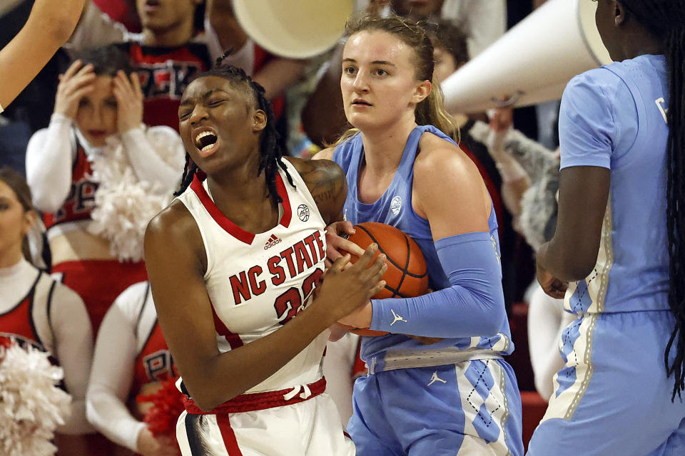 North Carolina State's Saniya Rivers (22) reacts following forcing a jump ball with North Carolina's Alyssa Ustby (1) during the second half of an NCAA college basketball game, Thursday, Feb. 1, 2024, in Raleigh, N.C. (AP Photo/Karl B. DeBlaker)