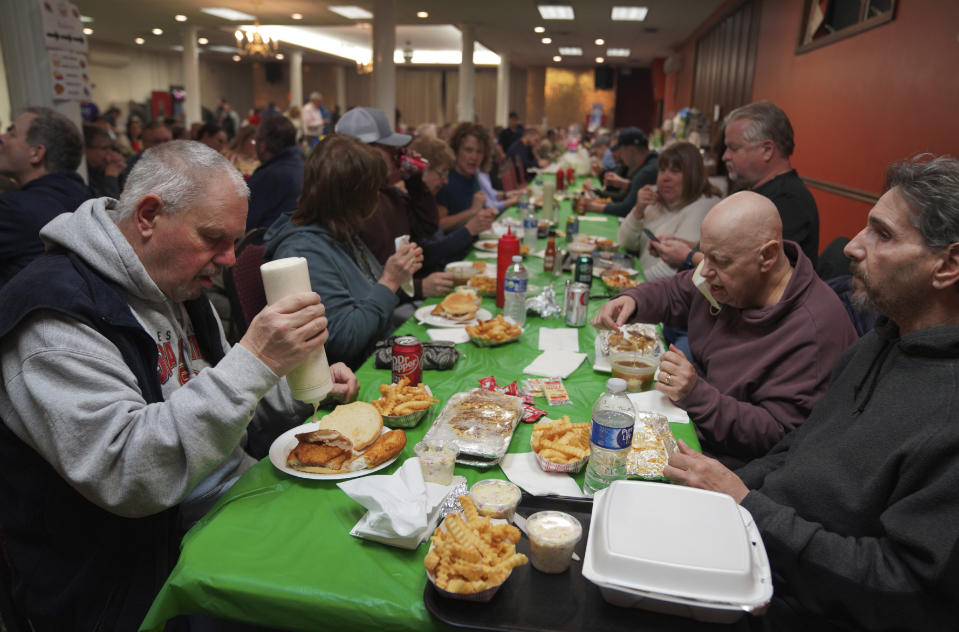 Groups pack the basement of St. Maximilian Kolbe Catholic Church during their annual fish fry on the first night of Lent, on Friday, Feb. 24, 2023, in the West Homestead neighborhood of Pittsburgh. (AP Photo/Jessie Wardarski)
