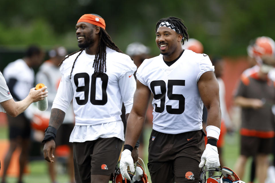 Cleveland Browns' Myles Garrett (95) and Jadeveon Clowney (90) take part in drills at the NFL football team's practice facility Tuesday, June 14, 2022, in Berea, Ohio. (AP Photo/Ron Schwane)