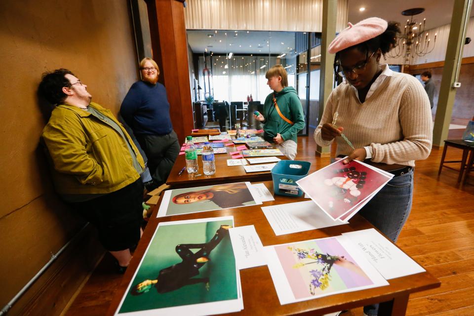 Local artist Petyr Cruikshanks, left, laughs with guests during the Transgender Day of Remembrance event at The Old Glass Place on Sunday, Nov. 20, 2022. About 18 trans artists participated in the event's artist showcase.