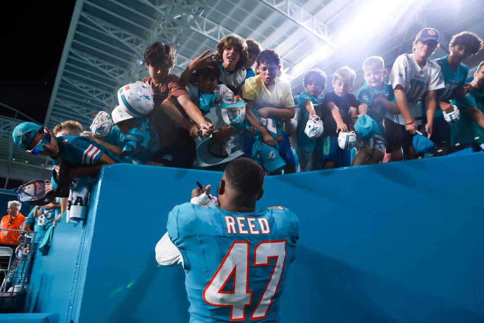 MIAMI GARDENS, FLORIDA – AUGUST 11: Malik Reed #47 of the Miami Dolphins signs autographs for fans after a preseason game against the Atlanta Falcons at Hard Rock Stadium on August 11, 2023 in Miami Gardens, Florida. (Photo by Megan Briggs/Getty Images)