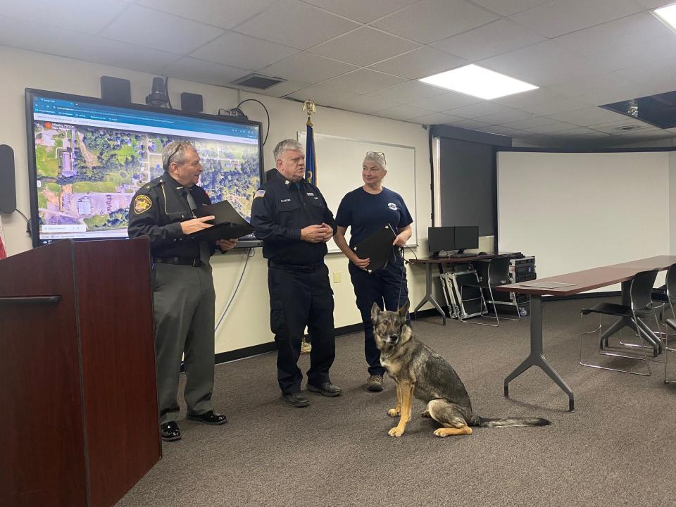 Richland County Sheriff J. Steve Sheldon, at left, thanks Capt. Alan Plastow and Sarah Gentry and K-9 Besa Tuesday. They are among members of the Ohio Special Response Search & Rescue Team honored for locating a missing man Sept. 15 in Richland County.