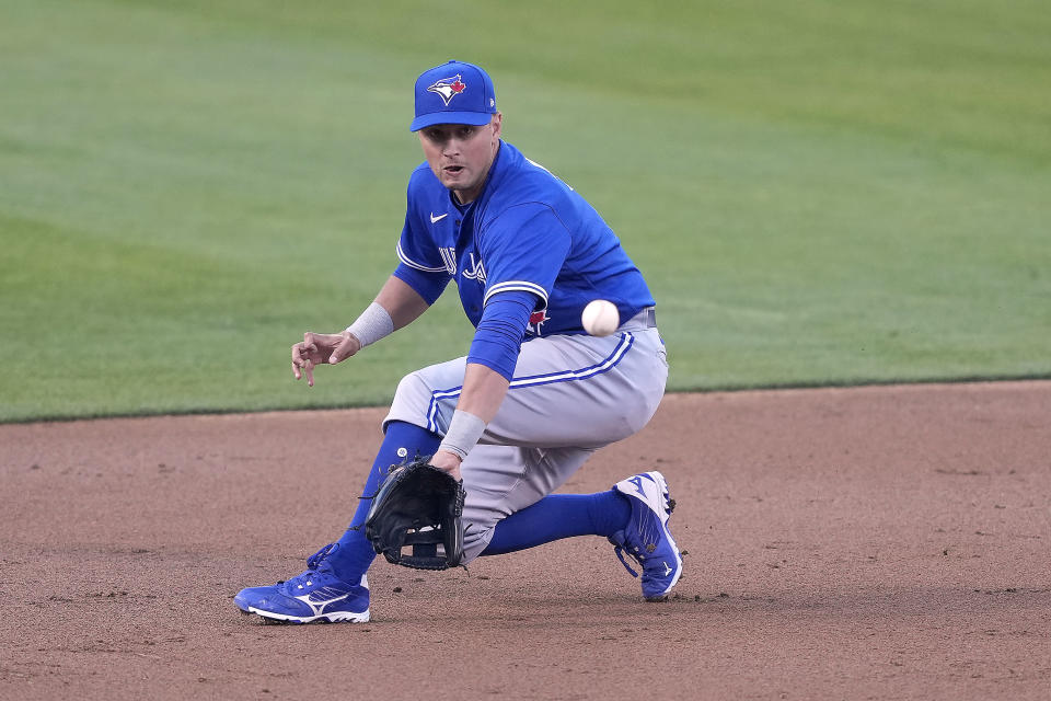 Toronto Blue Jays third baseman Joe Panik (2) fields a ground ball on a hit by Oakland Athletics' Sean Murphy during the first inning of a baseball game in Oakland, Calif., on Monday, May 3, 2021. (AP Photo/Tony Avelar)