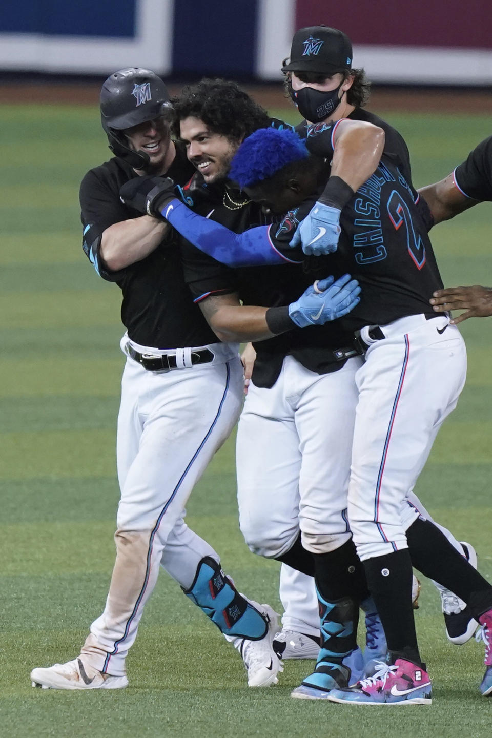 Miami Marlins' Jorge Alfaro, center, is congratulated after he hit a double in the 10th inning to drive in the winning run in the team's baseball game against the San Francisco Giants, Saturday, April 17, 2021, in Miami. The Marlins won 7-6. (AP Photo/Marta Lavandier)