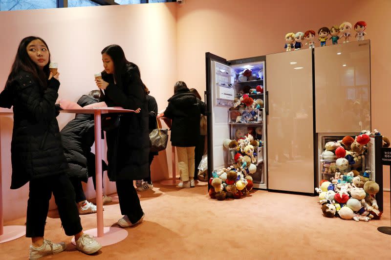 Fans of K-pop idol boy band BTS enjoy at a pop-up store selling BTS goods in Seoul