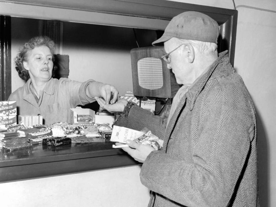 A man pays for concessions at a movie theater in 1956.