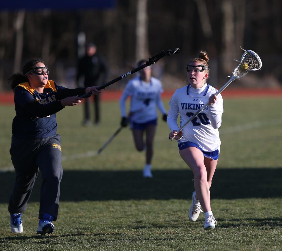 Brianna McPhillips of Valley Central (20) tries to drive. Action from Thursday's girls lacrosse home opener between Highland and Valley Central on March 21 2024.