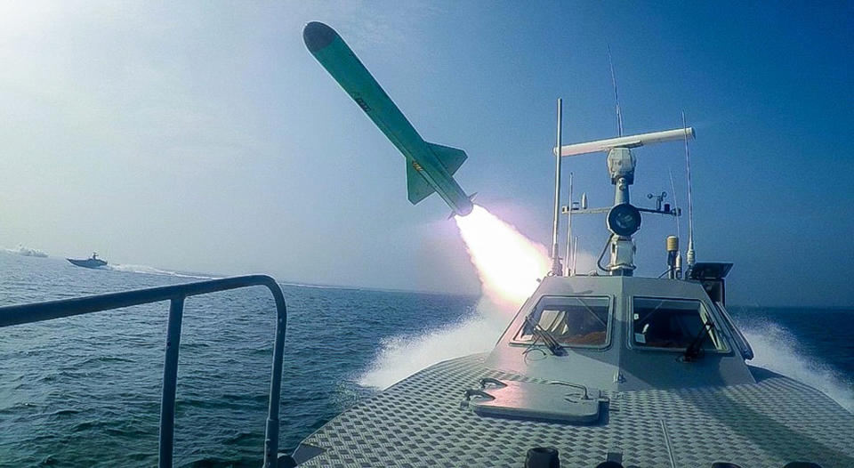 In this photo released Tuesday, July 28, 2020, by Sepahnews, a Revolutionary Guard's speed boat fires a missile during a military exercise. Iranian commandos also fast-roped down from a helicopter onto a replica of an aircraft carrier in the exercise called "Great Prophet 14." The drill appears aimed at threatening the U.S. amid tensions between Tehran and Washington. (Sepahnews via AP)