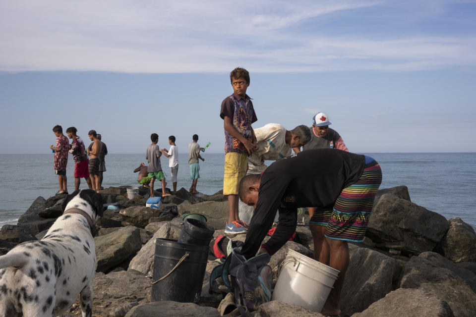 Fishermen on a jetty in La Sabana in September. (Andrea Hernández Briceño for The Washington Post)