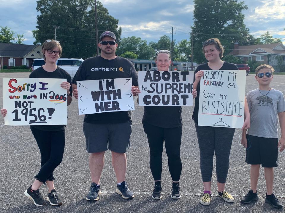 The Knapp family alongside signs at the March for Women's Reproductive Rights in Gadsden.