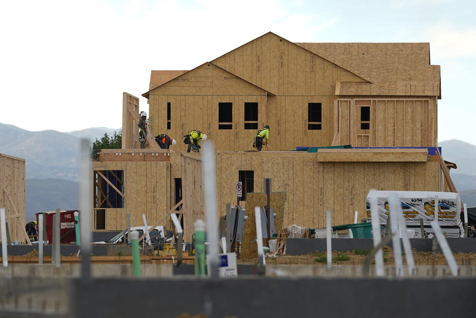 Workers toil on new homes in a housing development Tuesday, June 25, 2024, in Loveland, Colo. (AP Photo/David Zalubowski)