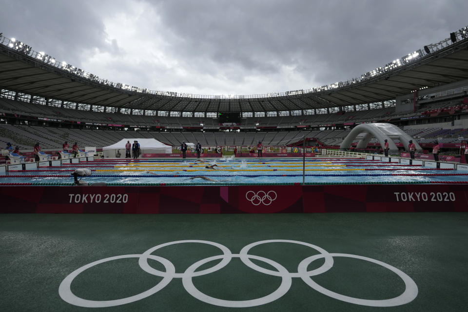 FILE - Athletes compete in the swimming portion of the men's modern pentathlon at the 2020 Summer Olympics, Saturday, Aug. 7, 2021, in Tokyo, Japan. Athletes at the last Summer Olympics remember the unmistakable sadness and longing of competing with nearly no one in the stands, thanks to pandemic-era restrictions in Tokyo three years ago. At the Paris Games, which begin this month, those folks can all join in for the ride, offering something that was missing the last time around on the big stage: a support system that can help improve results, help get through the tough moments and help celebrate the best ones. (AP Photo/Hassan Ammar, File)