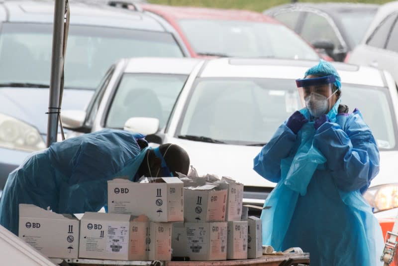 Health workers perform testing at a new drive-thru coronavirus disease (COVID-19) testing center at Bergen Community College in Paramus, New Jersey