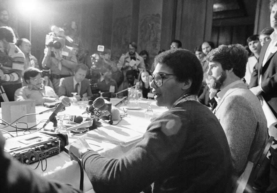 FILE - In this April 11, 1980, file photo, Anita DeFrantz, of Princeton, N.J., a member of the Olympic rowing team and the Olympic Advisory Council, talks to members of the media at a news conference in Colorado Springs, Colo. At her right is Peter Schnugg a member of the U.S. water polo team from Orinda, Calf. They discussed the athlete's view concerning a possible Olympic boycott. (AP Photo/Ed Andrieski, File)