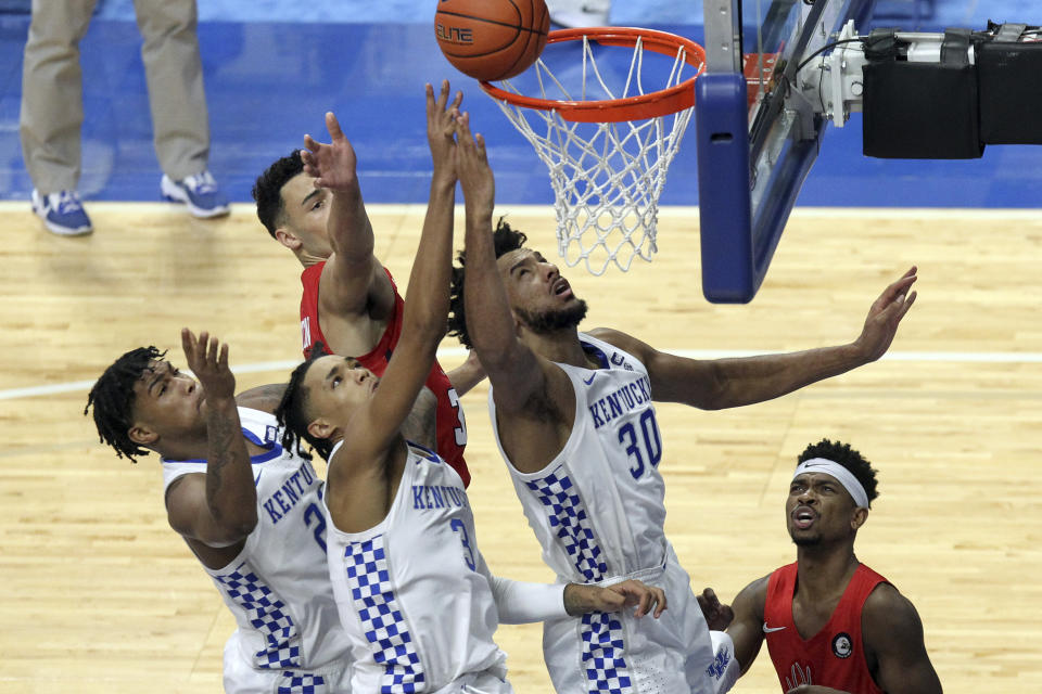 From front left to right, Kentucky's Cam'Ron Fletcher watches as B.J. Boston and Olivier Sarr try to tip the ball in as Richmond's Blake Francis looks on during the second half of an NCAA college basketball game in Lexington, Ky., Sunday, Nov. 29, 2020. (AP Photo/James Crisp)