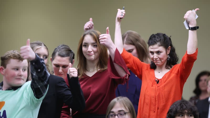 Elissa Ludlum, right, and others give a thumbs-up after hearing a public comment during a House Education Committee hearing concerning HB215 at the Capitol in Salt Lake City on Thursday, Jan. 19, 2023. More than 15,900 applications on behalf of 27,270 students were submitted for the Utah Fits All Scholarship.